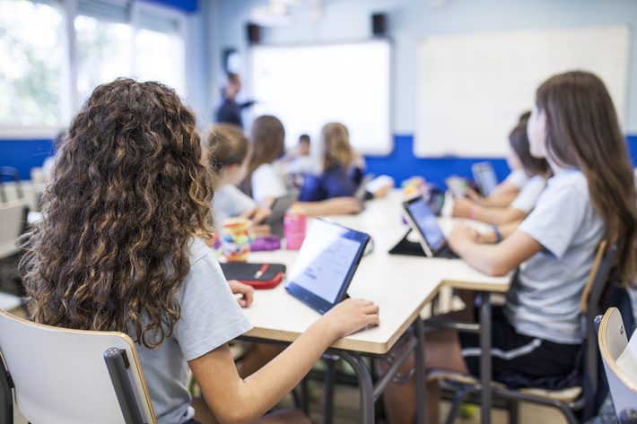 girl studies in class with her tablet