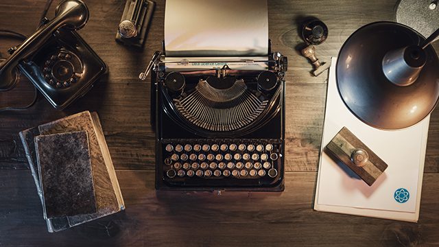 An old fashioned editor's desk with DSC logos