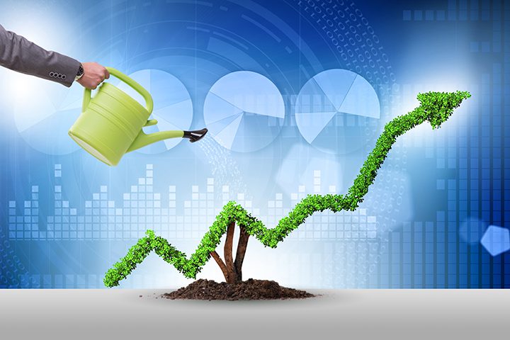 Businessman in investment concept watering financial line chart