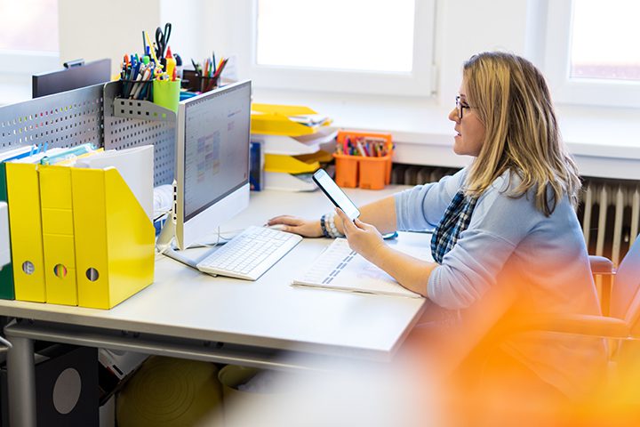 Female child therapist in an office during a phone call, using online calendar to schedule patients appointments. Calendar Planner Organization Management Concept.