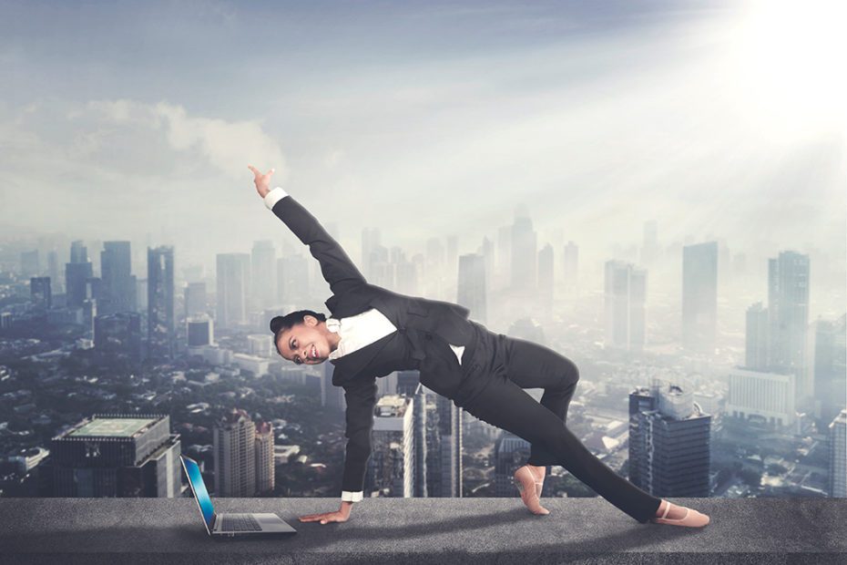 Female entrepreneur dancing with a laptop