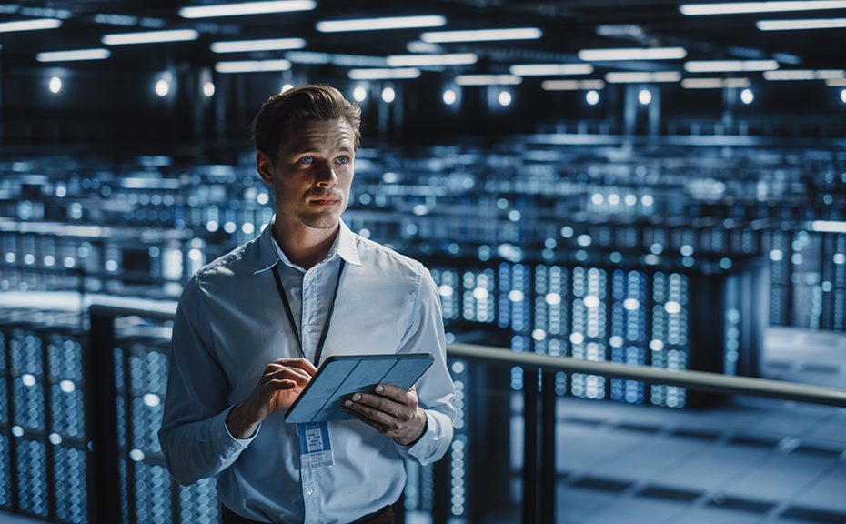 Portrait of Smiling IT Specialist Using Tablet Computer in Data