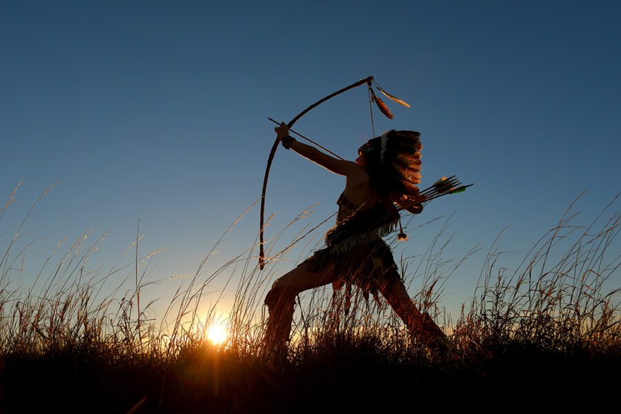A young girl plays the part of a native American Indian girl. Sh