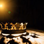 The crown on a black background is illuminated by a golden beam. Low-key image of a beautiful queen / royal crown Vintage is filtered. Fantasy of the medieval period. Game of Thrones.
