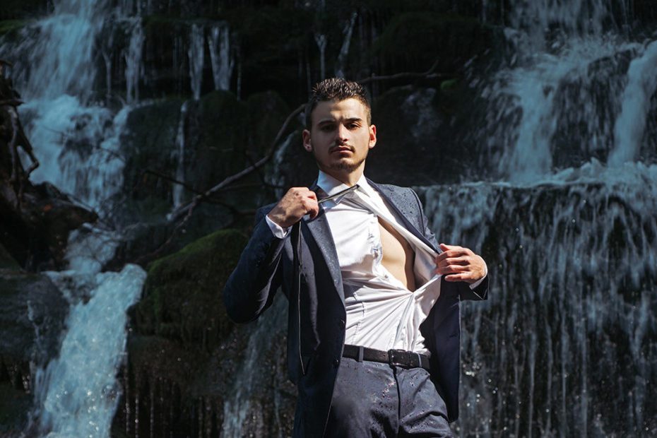 businessman undressing at waterfall ready to swim. business trip. summer vacation traveling. agile business. agine methodoly. Money waterfall and businessman. River of cash. relax of everyday life