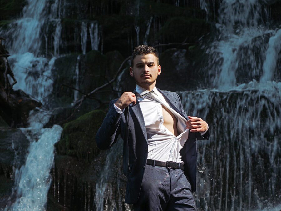 businessman undressing at waterfall ready to swim. business trip. summer vacation traveling. agile business. agine methodoly. Money waterfall and businessman. River of cash. relax of everyday life