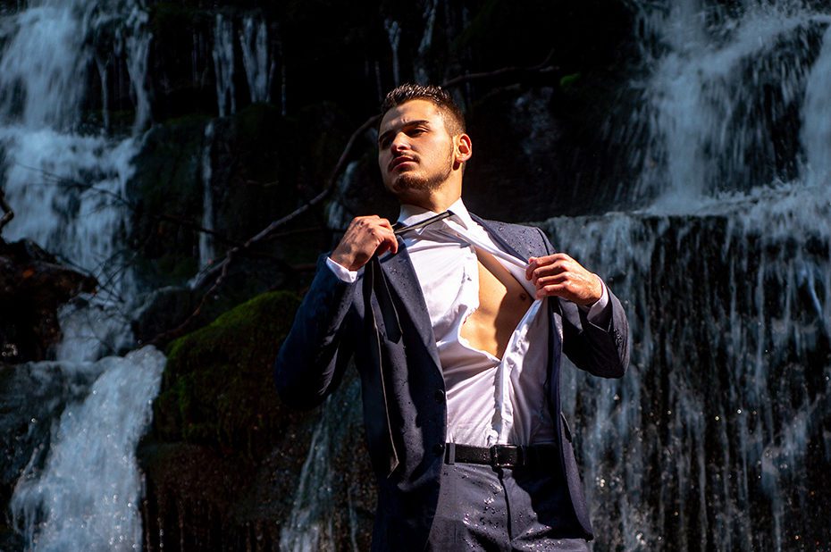 Profit business concept. businessman undressing at waterfall ready to swim. great finance waterfall. Wealth and success.