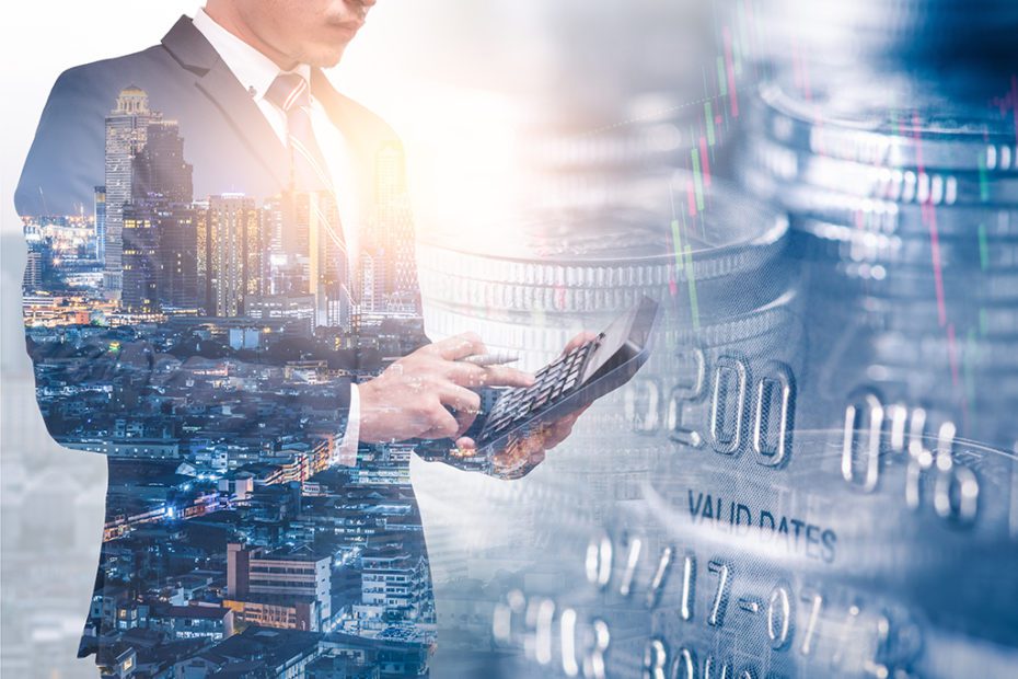 the double exposure image of businessman using a calculator over