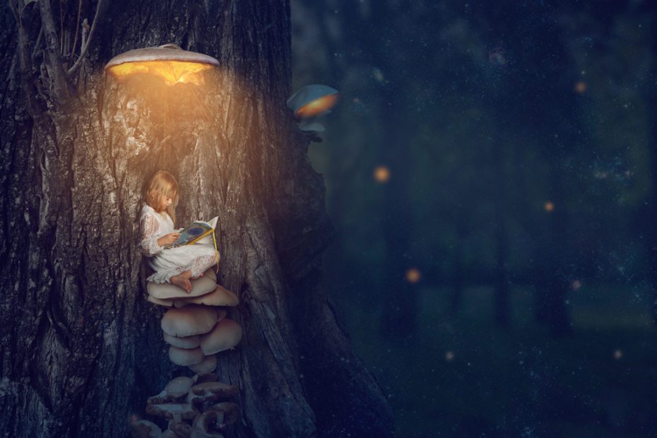 Enchanted forest – little girl sitting under the glowing mushroo
