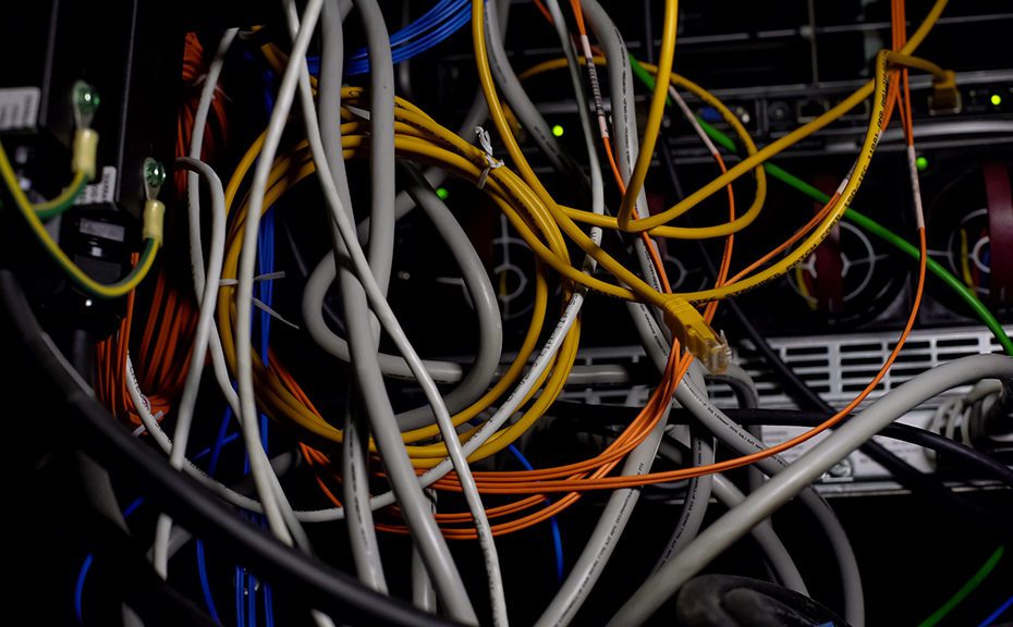 Tangled wires, power cables in datacenter, cabling mess in serve