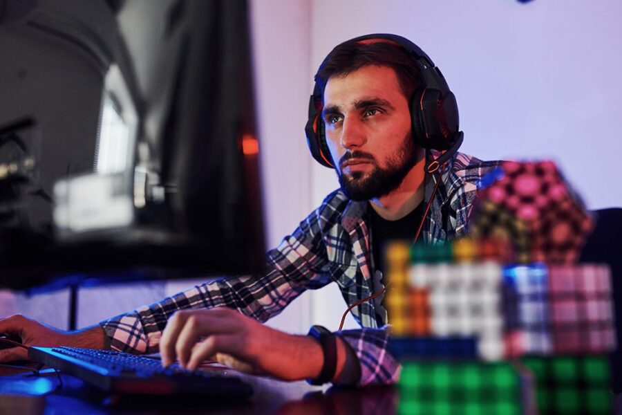 Portrait of young bearded pro gamer playing in online video game