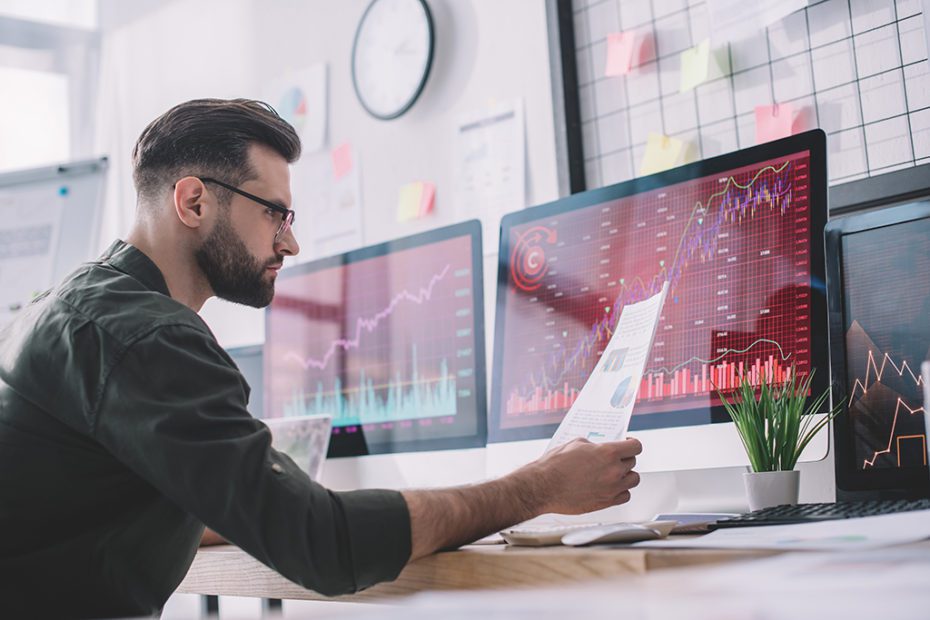 Side view of information security analyst looking at charts near