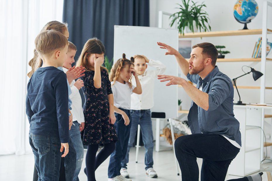 Storyteller with interesting information. Group of children students in class at school with teacher