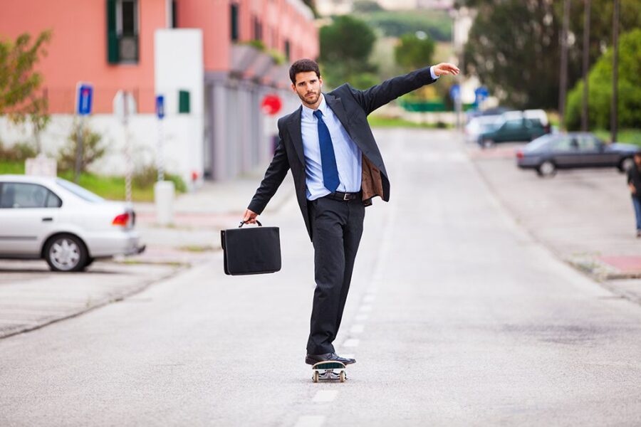 Businessman skateboarding
