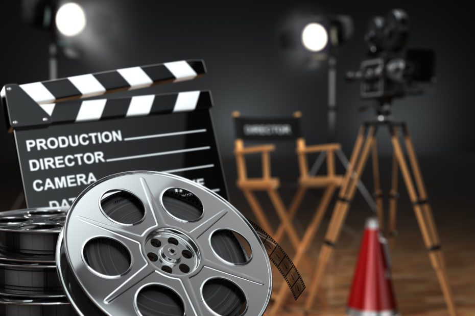 Video, movie, cinema concept. Retro camera, reels, clapperboard