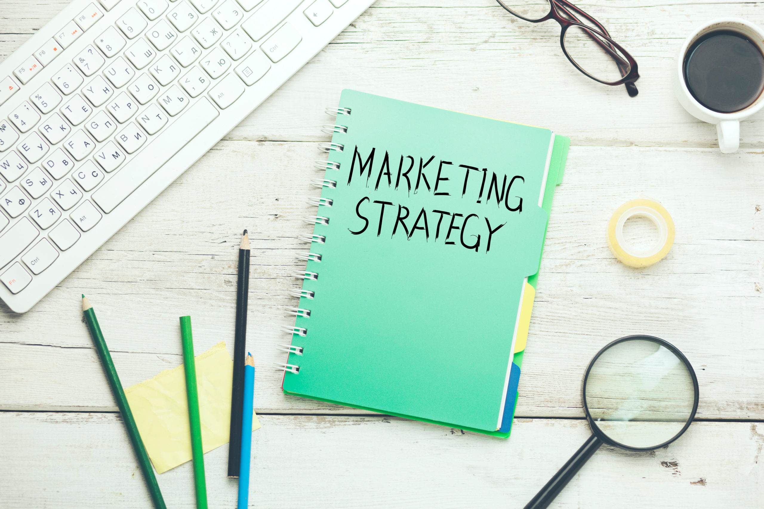 marketing strategy with keyboard and stationary on table