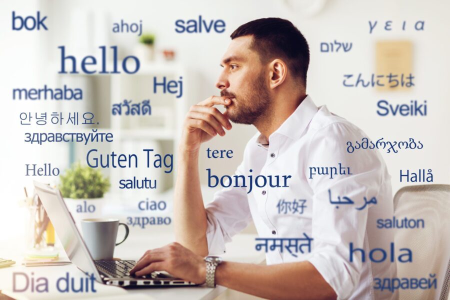 man with laptop over words in foreign languages