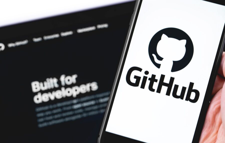 GitHub logo on the screen smartphone and notebook closeup. GitHu