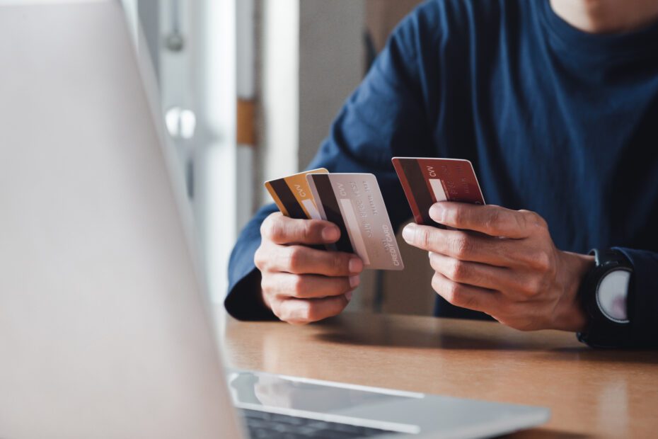A man holding multiple credit cards.
